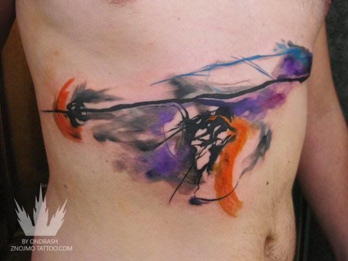 Czech tattoo artist Ondrash creates an abstract watercolor tattoo design with an artistic effect