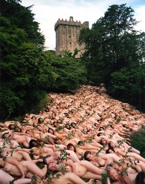 One of Spencer Tunick's mass nude photographs that uses dozens of naked women with roses in their mouths