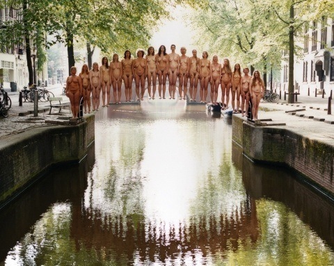 One of Spencer Tunick's mass nude photographs that uses thousands of volunteers to create a naked bridge in the netherlands