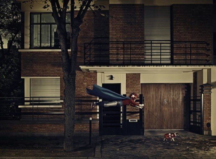 A funny photo by Sacha Goldberger of his grandmother in a superhero outfit flying her dog down the road