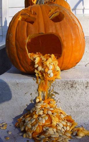 A funny halloween picture of a pumpkin puking its guts out