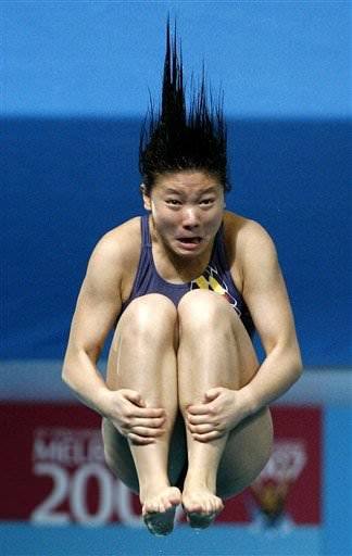 A funny sports picture of a girl pulling faces while diving