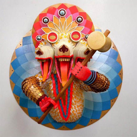 A 3D wood art work by AJ Fosik of a psychedelic wolf with three mouths holding a mallet