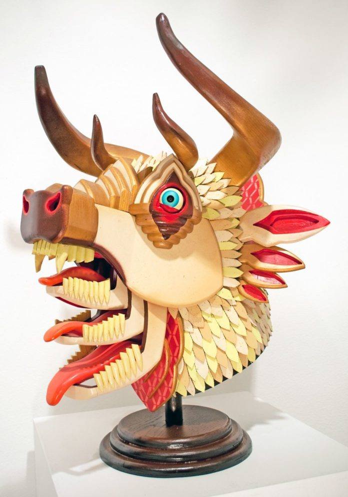 A cool sculpture of a bull with three mouths by American artist AJ Fosik