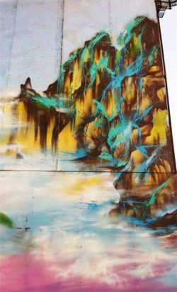 A building in China transforms into a misty mountain scene in this graffiti painting by hua Tunan