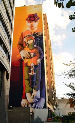 A mother and child appear together in this enormous graffiti painting by street artist Inti