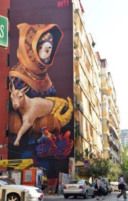 An enormous pop surrealist street art work of a sheperd with a lamb by graffiti artist Inti