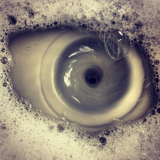 An optical illusion created by water in a sink looks like a human eye
