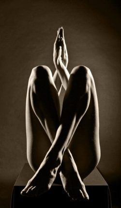 Beautiful nude photograph of a woman in a twisted pose