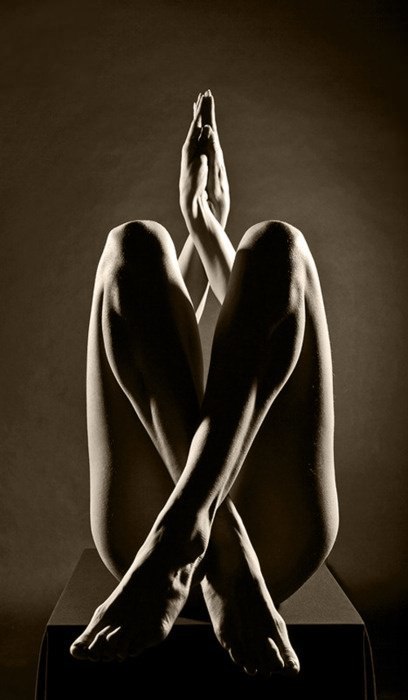 Beautiful nude photograph of a woman in a twisted pose