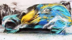 Chinese graffiti artist paints an eagle on a subaru, combining street art and traditional art styles