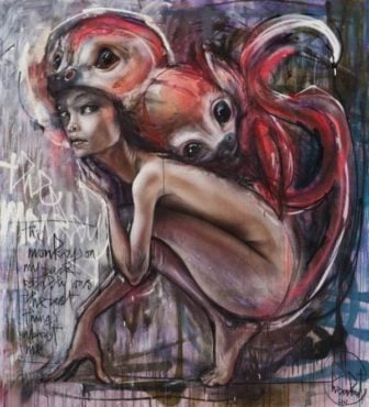 A beautiful nude girl poses with a monkey on her back in this graffiti painting by Herakut
