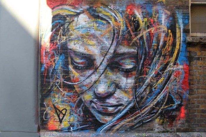 A colorful graffiti portrait of a pretty girl by London street artist David Walker