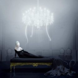 A pale woman with tentacles lies ona couch beneath a glowing chandelier in this painting by Ray Caesar