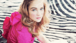 A pretty girl in pink blinks for the camera in this beautiful and silent animated GIF by Cinemagraphs