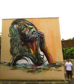 A beautiful woman poses eternally in this large street art mural by french graffiti artist Hopare