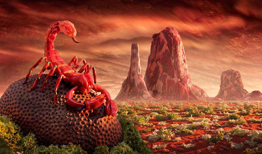A red scorpion poses in the foreground of this foodscape, an artwork made out of food, by Chris Warner