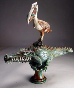 A grumpy crocodile loses his lunch to a cheeky pelican in this funny sculpture by Mitchell Grafton