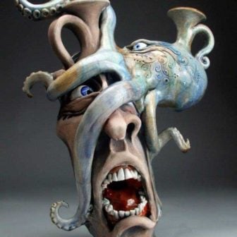 An octopus suckers this guy into wearing it as a mask in this pottery sculpture by Michael Grafton