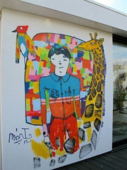 Mart Aire paints a boy dreaming of nature in this colorful graffiti mural